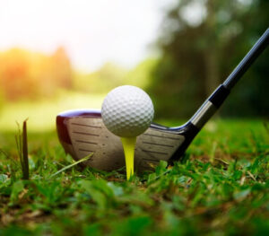 Close-up of a golf ball teed up on grass, ready for the first swing, symbolising the importance of preparation before play.
