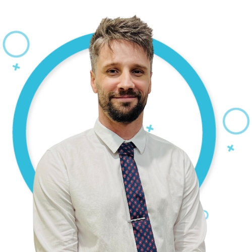 Professional headshot of Joshua Kunde, Administrator, in a white shirt and patterned tie, with a graphic blue circle and design elements in the background.
