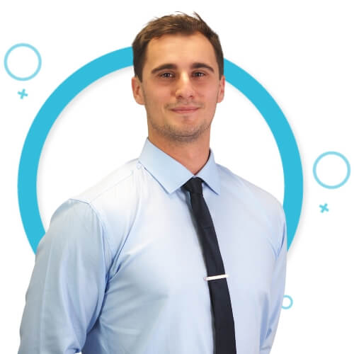 Matt Ivan, physiotherapist at M Physio Gold Coast, smiling in front of a blue circular clinic logo