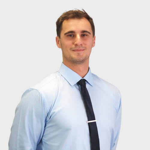 Professional portrait of Matt Ivan, physiotherapist at M Physio Gold Coast, in a blue shirt and black tie