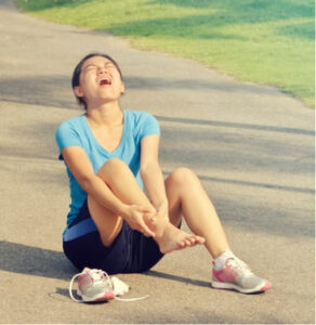 Woman in pain from an untreated sprain during outdoor exercise