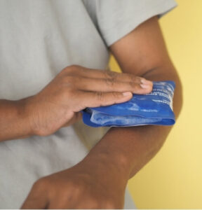 Applying ice pack to arm for acute injury, an early step in corked muscle physiotherapy