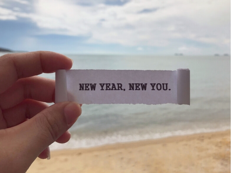 New Year message on beach — motivation peaks while new year fitness injuries rise