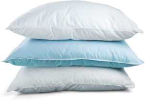 Three stacked pillows highlighting the importance of pillow choice for spinal support during sleep