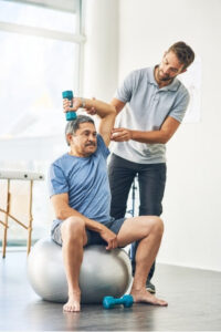 Physiotherapist assisting older man with shoulder rehab – part of rib pain physiotherapy treatment