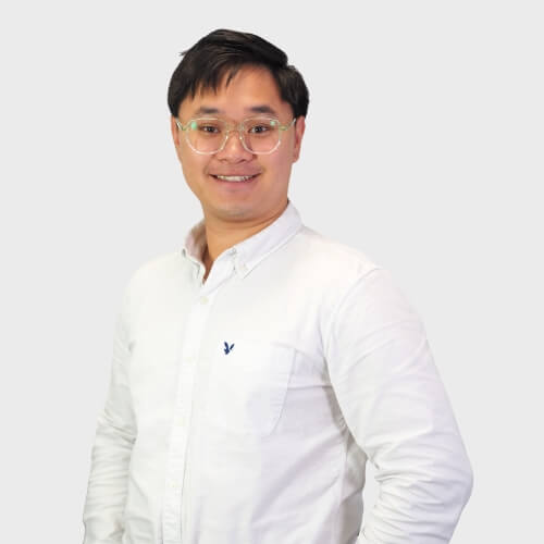 Portrait of Austin Chua on a grey background.