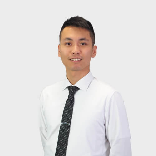 Portrait of Marco Lin in front of plain light grey background.