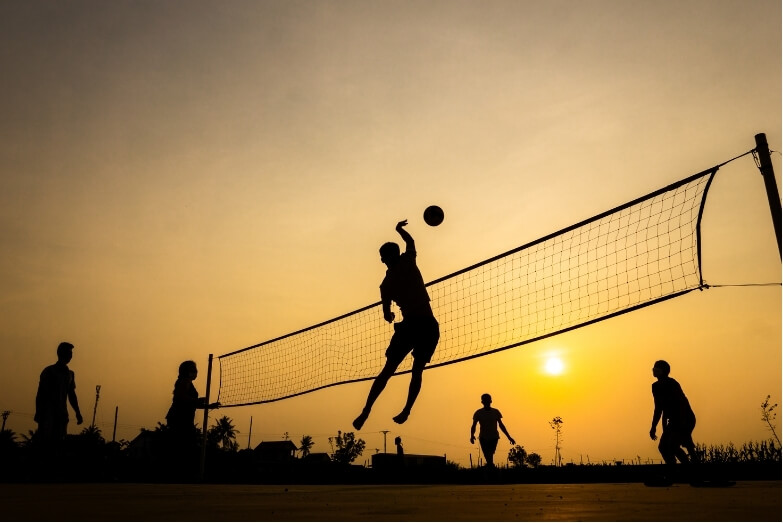 Volleyball in the sunset is a sport where you can see common summer sports injuries