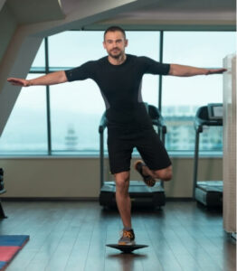 Man performing single-leg balance exercise to improve balance training for falls prevention