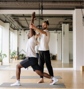 Physiotherapist guiding exercise to address muscle tightness causes through strengthening and movement control