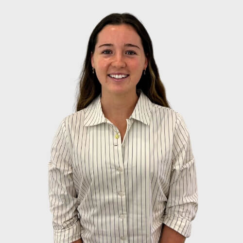 Portrait photo of Summah Joyce standing in front of a grey background