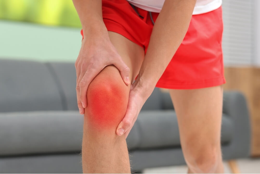 Person experiencing front knee pain during movement assessment in physiotherapy
