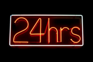 Illuminated 24-hour sign representing the 24-hour rule for exercise and next-day symptom monitoring.